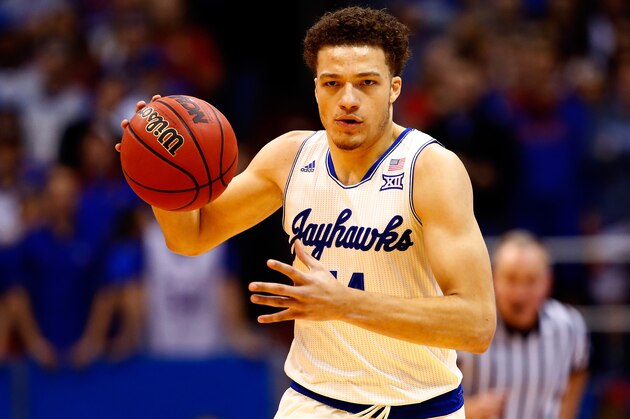 LAWRENCE, KS - DECEMBER 09:  Brannen Greene #14 of the Kansas Jayhawks drives toward the basket during the game against the Holy Cross Crusaders at Allen Fieldhouse on December 9, 2015 in Lawrence, Kansas.  (Photo by Jamie Squire/Getty Images)