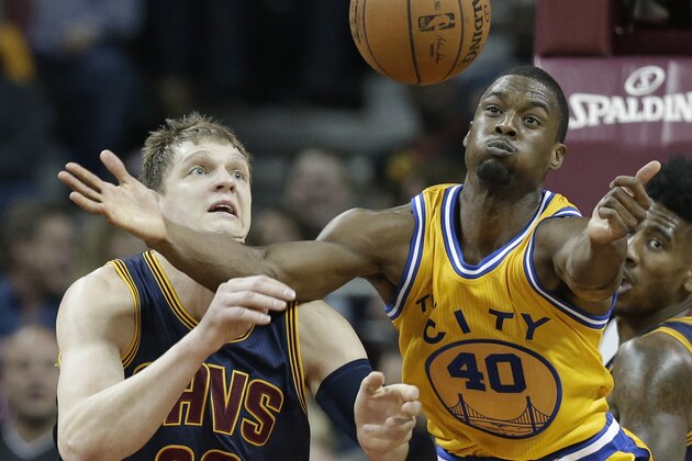 Golden State Warriors’ Harrison Barnes (40) and Cleveland Cavaliers' Timofey Mozgov (20), from Russia, battle for a loose ball in the second half of an NBA basketball game Monday, Jan. 18, 2016, in Cleveland. The Warriors won 132-98. (AP Photo/Tony Dejak)
