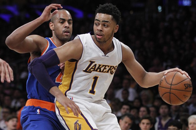Los Angeles Lakers guard D'Angelo Russell (1) backs into New York Knicks guard Arron Afflalo (4) during the second half of an NBA basketball game in Los Angeles, Sunday, March 13, 2016. The Knicks won 90-87. (AP Photo/Alex Gallardo)