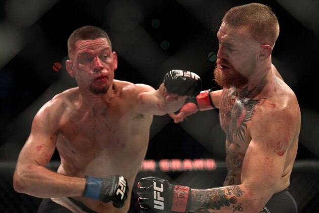 LAS VEGAS, NV - MARCH 5:   (L-R) Nate Diaz punches Conor McGregor in their welterweight bout during the UFC 196 in the MGM Grand Garden Arena on March 5, 2016 in Las Vegas, Nevada. (Photo by Brandon Magnus/Zuffa LLC/Zuffa LLC via Getty Images)