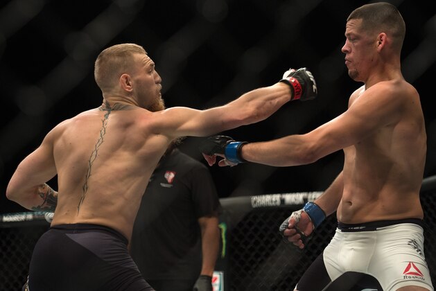 LAS VEGAS, NV - MARCH 5:   (L-R) Conor McGregor punches Nate Diaz in their welterweight bout during the UFC 196 in the MGM Grand Garden Arena on March 5, 2016 in Las Vegas, Nevada. (Photo by Brandon Magnus/Zuffa LLC/Zuffa LLC via Getty Images)