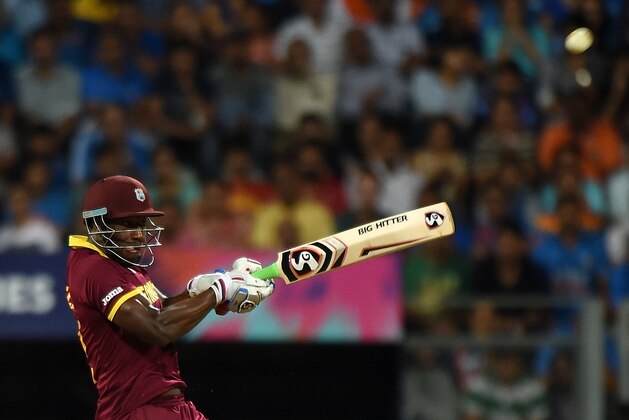 West Indies batsman Andre Russell plays a shot during the World T20 cricket tournament semi-final match between India and West Indies at The Wankhede Cricket Stadium in Mumbai on March 31, 2016. / AFP / PUNIT PARANJPE        (Photo credit should read PUNIT PARANJPE/AFP/Getty Images)
