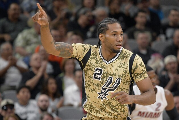 San Antonio Spurs forward Kawhi Leonard celebrates a 3-point basket during the first half of an NBA basketball game against the Miami Heat, Wednesday, March 23, 2016, in San Antonio. (AP Photo/Darren Abate)