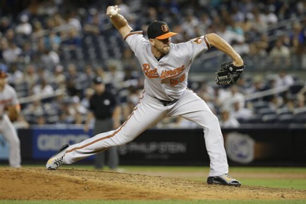 FILE - In this Sept. 9, 2015, file photo, Baltimore Orioles' Darren O'Day delivers a pitch during the eighth inning of a baseball game against the New York Yankees, in New York. All-Star reliever Darren O'Day and the Orioles have completed a $31 million, four-year contract. The Orioles announced Monday, Dec. 14, 2015,  that the 33-year-old free agent had re-signed with the team. (AP Photo/Frank Franklin II, File)