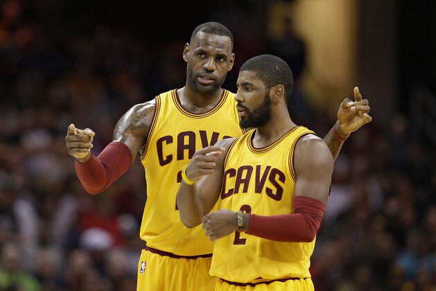 Cleveland Cavaliers' LeBron James, back, talks with Kyrie Irving in the first half of an NBA basketball game against the Orlando Magic, Saturday, Jan. 2, 2016, in Cleveland. (AP Photo/Tony Dejak)