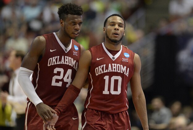 March 26, 2016; Anaheim, CA, USA; Oklahoma Sooners guard Buddy Hield (24) speaks to guard Jordan Woodard (10) during a stoppage in play against Oregon Ducks during the second half of the West regional final of the NCAA Tournament at Honda Center. Mandatory Credit: Richard Mackson-USA TODAY Sports