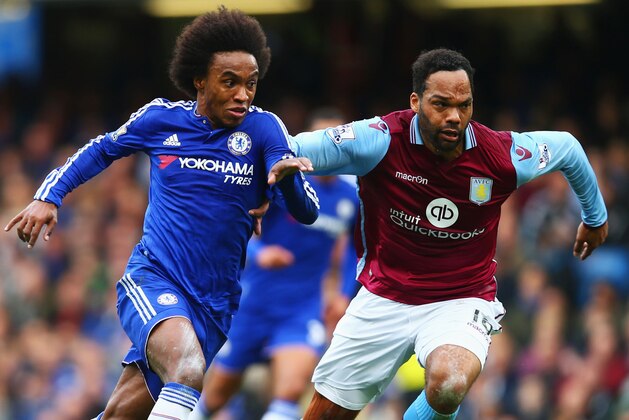 LONDON, ENGLAND - OCTOBER 17: Willian of Chelsea and Joleon Lescott of Aston Villa compete for the ball during the Barclays Premier League match between Chelsea and Aston Villa at Stamford Bridge on October 17, 2015 in London, England.  (Photo by Clive Rose/Getty Images)