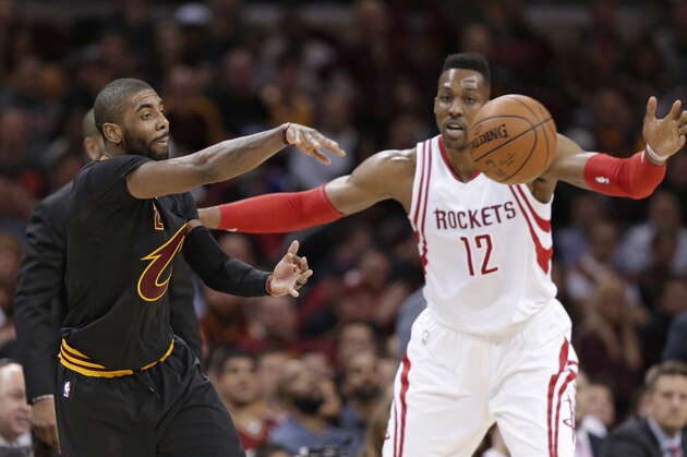 Cleveland Cavaliers' Kyrie Irving (2) passes around Houston Rockets' Dwight Howard (12) in the first half of an NBA basketball game Tuesday, March 29, 2016, in Cleveland. (AP Photo/Tony Dejak) Cleveland Cavaliers' Kyrie Irving (2) passes around Houston Rockets' Dwight Howard (12) in the first half of an NBA basketball game Tuesday, March 29, 2016, in Cleveland. (AP Photo/Tony Dejak)