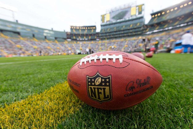 Aug 29, 2015; Green Bay, WI, USA; NFL footballs sit on the field during warmups prior to the game between the Philadelphia Eagles and Green Bay Packers at Lambeau Field.  Philadelphia won 39-26.  Mandatory Credit: Jeff Hanisch-USA TODAY Sports