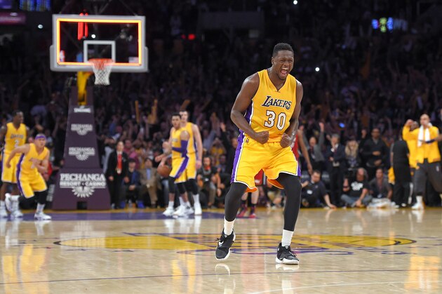Los Angeles Lakers forward Julius Randle, front, celebrates as the Lakers defeat the Miami Heat in overtime in an NBA basketball game, Wednesday, March 30, 2016, in Los Angeles. The Lakers won 102-100. (AP Photo/Mark J. Terrill)