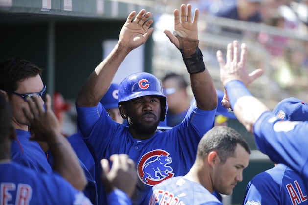 Chicago Cubs' Dexter Fowler is greeted by teammates during a spring training baseball game against the Cincinnati Reds Tuesday, March 22, 2016, in Goodyear, Ariz. (AP Photo/Jae C. Hong)