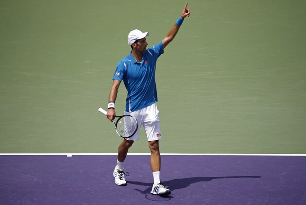 Apr 1, 2016; Key Biscayne, FL, USA; Novak Djokovic gestures after winning the first set tiebreaker against David Goffin (not pictured) during a men's singles semifinal on day twelve of the Miami Open at Crandon Park Tennis Center. Mandatory Credit: Geoff Burke-USA TODAY Sports