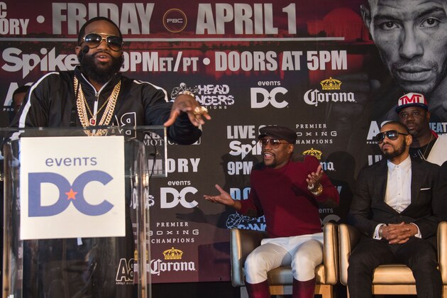 Promoter and former champion boxer Floyd Mayweather (C) gestures as WBA super lightweight champion Adrien Broner (L) talks about his upcoming fight against Ashley Theophane (R) during a press conference in Washington, DC, February 29, 2016.  
The title contest is scheduled to take place April 1, 2016 at the D.C. Armory in Washington DC. / AFP / JIM WATSON        (Photo credit should read JIM WATSON/AFP/Getty Images)