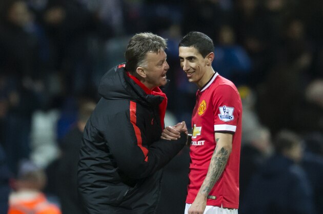 Manchester United's manager Louis van Gaal, left, speaks with Angel Di Maria during the English FA Cup Fifth Round soccer match between Preston and Manchester United at Deepdale Stadium in Preston, England, Monday Feb. 16, 2015.  (AP Photo/Jon Super)