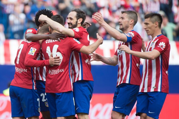 Atletico Madrid's French forward Antoine Griezmann celebrates with teammates after scoring during the Spanish league football match Club Atletico de Madrid vs Real Betis Balompi at the Vicente Calderon stadium in Madrid on April 2, 2016. / AFP / CURTO DE LA TORRE        (Photo credit should read CURTO DE LA TORRE/AFP/Getty Images)