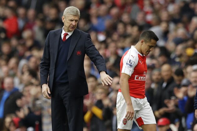 Arsenal's French manager Arsene Wenger pats Alexis Sanchez as he leaves the pitch after being substituted during the English Premier League soccer match between Arsenal and Watford at the Emirates Stadium in London, Saturday, April 2, 2016.  (AP Photo/Matt Dunham)