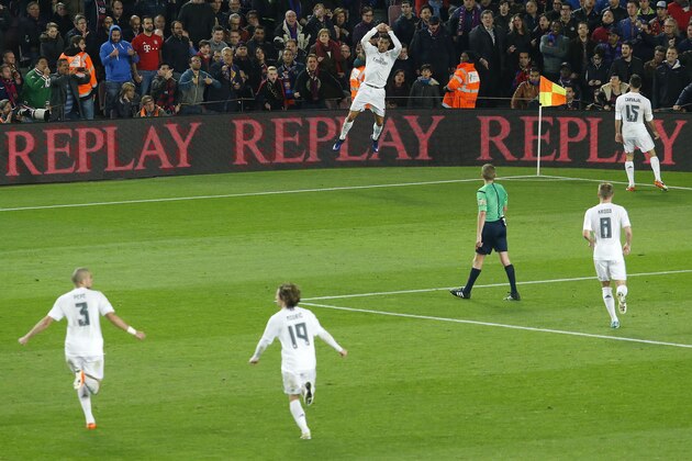Real Madrid's Portuguese forward Cristiano Ronaldo (UP) celebrates after scoring during the Spanish league 'Clasico' football match FC Barcelona vs Real Madrid CF at the Camp Nou stadium in Barcelona on April 2, 2016. / AFP / PAU BARRENA        (Photo credit should read PAU BARRENA/AFP/Getty Images)