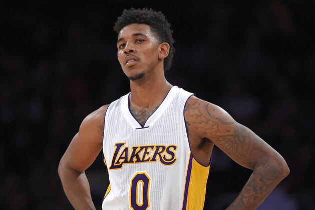 Los Angeles Lakers forward Nick Young looks on during the second half of an NBA basketball game against the Phoenix Suns, Sunday, Dec. 28, 2014, in Los Angeles.  The Suns won 116-107. (AP Photo/Mark J. Terrill)