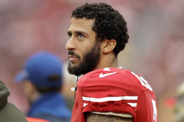 FILE - In this Nov. 8, 2015, file photo, San Francisco 49ers quarterback Colin Kaepernick stands on the field during an NFL football game against the Atlanta Falcons in Santa Clara, Calif. After months of trade talk and speculation, Kaepernick is still on the 49er's roster and due a hefty payday. The quarterback's $11.9 million 2016 contract became guaranteed at 1 p.m. local time Thursday, March 31, 2016, when the 49ers kept him on the roster. (AP Photo/Ben Margot, File)