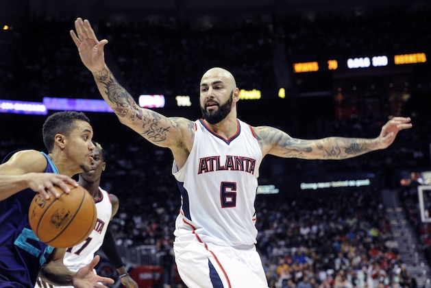 Atlanta Hawks forward Pero Antic, of Macedonia, (6) guards Charlotte Hornets guard Brian Roberts, left, during the second half of an NBA basketball game, Friday, April 10, 2015, in Atlanta. Atlanta won 104-80. Antic was arrested along with fellow teammate Thabo Sefolosha, from Switzerland, and released on charges they blocked officers from setting up a crime scene following the stabbing of Indiana Pacers' Chris Copeland during an incident Wednesday, April 8, 2015 in New York. (AP Photo/John Amis)