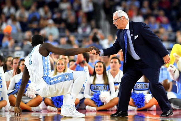 Apr 2, 2016; Houston, TX, USA; North Carolina Tar Heels head coach Roy Williams helps North Carolina Tar Heels forward Theo Pinson (1) off the floor during the first half against the Syracuse Orange in the 2016 NCAA Men's Division I Championship semi-final game at NRG Stadium. Mandatory Credit: Bob Donnan-USA TODAY Sports