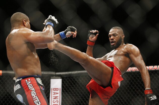 Jon Jones kicks Daniel Cormier during their light heavyweight title mixed martial arts bout at UFC 182, Saturday, Jan. 3, 2015, in Las Vegas. (AP Photo/John Locher)
