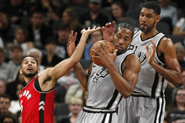 SAN ANTONIO,TX - APRIL 2: Kawhi Leonard #2 of the San Antonio Spurs grabs a rebound between Cory Joseph #6 of the Toronto Raptors and Tim Duncan #21 of the San Antonio Spurs at AT&T Center on April 2, 2016 in San Antonio, Texas. NOTE TO USER: User expressly acknowledges and agrees that , by downloading and or using this photograph, User is consenting to the terms and conditions of the Getty Images License Agreement. (Photo by Ronald Cortes/Getty Images) SAN ANTONIO,TX - APRIL 2: Kawhi Leonard #2 of the San Antonio Spurs grabs a rebound between Cory Joseph #6 of the Toronto Raptors and Tim Duncan #21 of the San Antonio Spurs at AT&T Center on April 2, 2016 in San Antonio, Texas. NOTE TO USER: User expressly acknowledges and agrees that , by downloading and or using this photograph, User is consenting to the terms and conditions of the Getty Images License Agreement. (Photo by Ronald Cortes/Getty Images)
