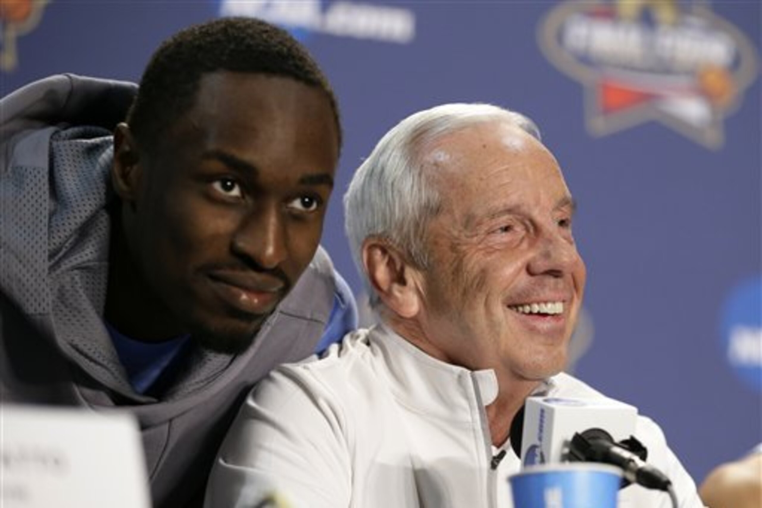 North Carolina's Theo Pinson comes up to the stage to have some fun with head coach Roy Williams and his teammates during a news conference for the NCAA Final Four tournament college basketball championship game Sunday, April 3, 2016, in Houston. (AP Photo/Charlie Neibergall)