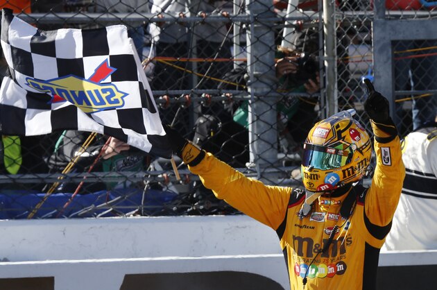 Kyle Busch celebrates winning the Sprint Cup auto race at Martinsville Speedway on Sunday, April 3, 2016, in Martinsville, Va. (AP Photo/Steve Helber)