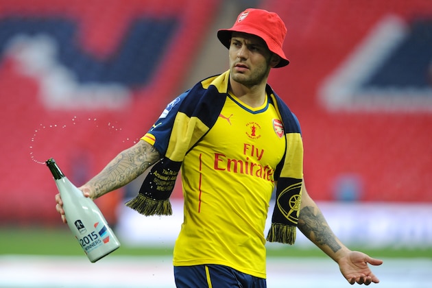 Arsenal's Jack Wilshere walks off the pitch after his team won the English FA Cup final soccer match between Aston Villa and Arsenal at Wembley stadium in London, Saturday, May 30, 2015. Arsenal won the match 4-0. (AP Photo/Rui Vieira)
