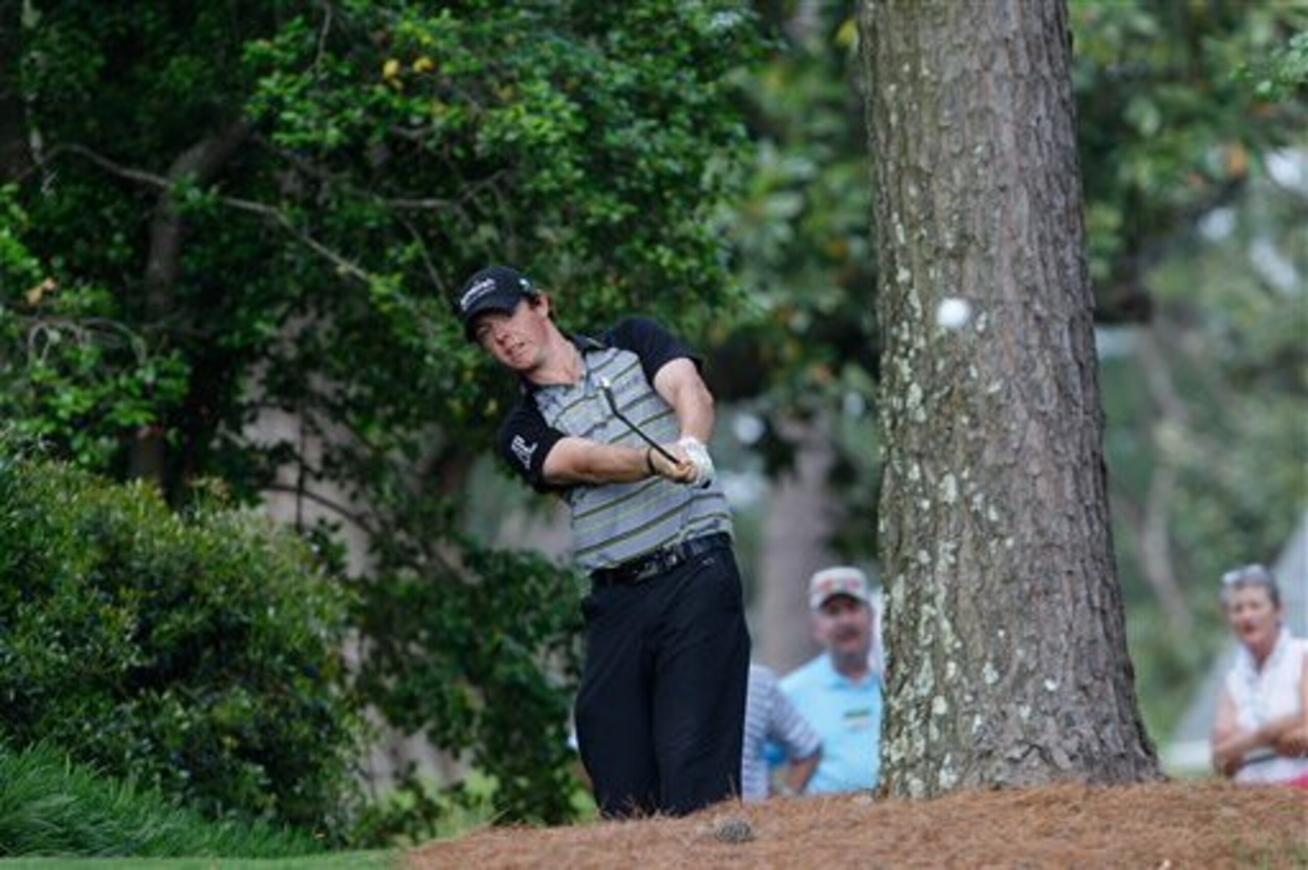 Rory McIlroy of Northern Ireland hits his ball out from next to a cabin during the final round of the Masters golf tournament Sunday, April 10, 2011, in Augusta, Ga. McIlroy was playing his second shot of the 10th hole. (AP Photo/Dave Martin)(AP Photo/Dave Martin)