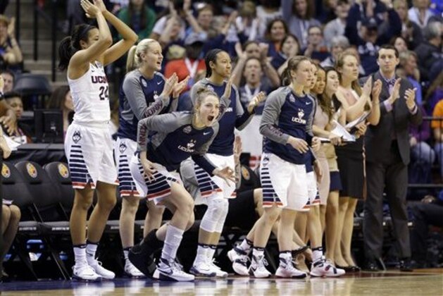 Connecticut's Katie Lou Samuelson, second from left, joins the bench to cheer during the second half of a national semifinal game against Oregon State, at the women's Final Four in the NCAA college basketball tournament Sunday, April 3, 2016, in Indianapolis. (AP Photo/Michael Conroy)