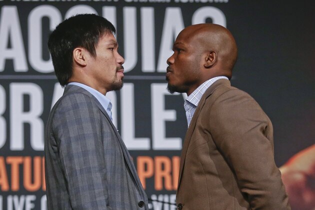 Manny Pacquiao, left, and Timothy Bradley pose for photographs during a news conference to promote an upcoming boxing match Thursday, Jan. 21, 2016, in New York. (AP Photo/Frank Franklin II)