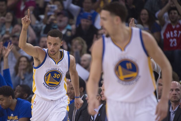 April 3, 2016; Oakland, CA, USA; Golden State Warriors guard Stephen Curry (30) celebrates after making a basket as guard Klay Thompson (11) looks on during the first quarter against the Portland Trail Blazers at Oracle Arena. Mandatory Credit: Kyle Terada-USA TODAY Sports