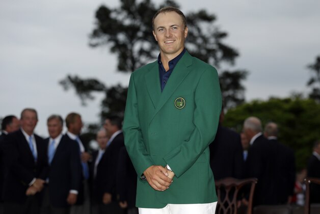 Jordan Spieth poses with his green jacket after winning the Masters golf tournament Sunday, April 12, 2015, in Augusta, Ga. (AP Photo/David J. Phillip)