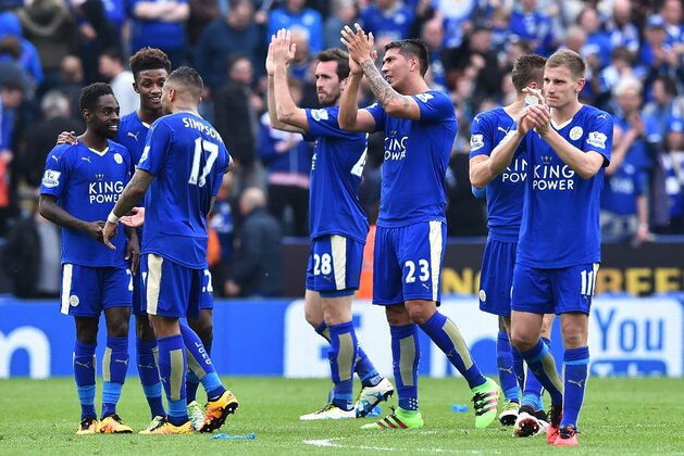 Leicester City's Austrian defender Christian Fuchs (C) and Leicester City's Argentinian striker Leonardo Ulloa applaud fans after winning the English Premier League football match between Leicester City and Southampton at King Power Stadium in Leicester, central England on April 3, 2016. / AFP / BEN STANSALL / RESTRICTED TO EDITORIAL USE. No use with unauthorized audio, video, data, fixture lists, club/league logos or 'live' services. Online in-match use limited to 75 images, no video emulation. No use in betting, games or single club/league/player publications.  /         (Photo credit should read BEN STANSALL/AFP/Getty Images)