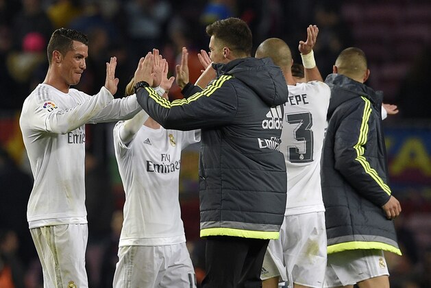 Real Madrid's Portuguese forward Cristiano Ronaldo (L) celebrates after the Spanish league 'Clasico' football match FC Barcelona vs Real Madrid CF at the Camp Nou stadium in Barcelona on April 2, 2016. / AFP / LLUIS GENE        (Photo credit should read LLUIS GENE/AFP/Getty Images)