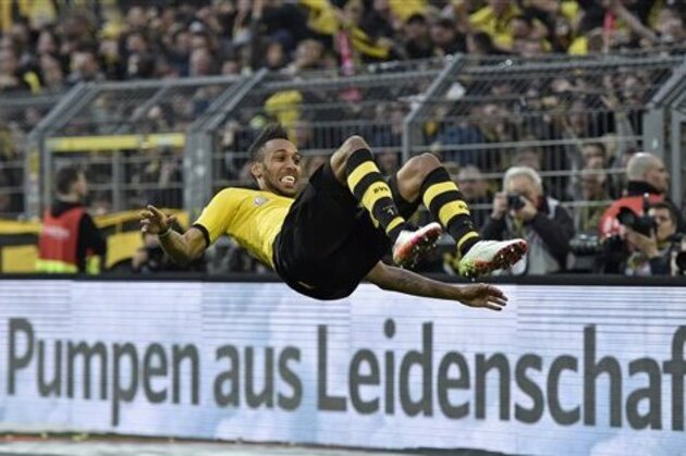 Dortmund's Pierre-Emerick Aubameyang celebrates his opening goal with a salto summersault during the German Bundesliga soccer match between Borussia Dortmund and Werder Bremen in Dortmund, Germany, Saturday, April 2, 2016.  An advertisement reads