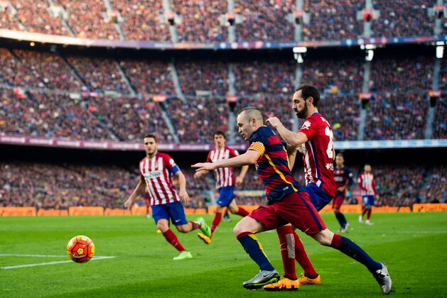 BARCELONA, SPAIN - JANUARY 30: Andres Iniesta of FC Barcelona conducts the ball under a challenge of Juanfran Torres of Club Atletico de Madrid during the La Liga match between FC Barcelona and Club Atletico de Madrid at Camp Nou on January 30, 2016 in Barcelona, Spain. (Photo by Alex Caparros/Getty Images)