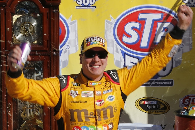 Kyle Busch celebrates after winning the Sprint Cup auto race at Martinsville Speedway, Sunday, April 3, 2016, in Martinsville, Va. (AP Photo/Steve Helber)