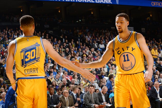 OAKLAND, CA - MARCH 29: Stephen Curry #30 of the Golden State Warriors high fives teammate Klay Thompson #11 during the game against the Washington Wizards on March 29, 2016 at Oracle Arena in Oakland, California. NOTE TO USER: User expressly acknowledges and agrees that, by downloading and or using this photograph, user is consenting to the terms and conditions of Getty Images License Agreement. Mandatory Copyright Notice: Copyright 2016 NBAE (Photo by Noah Graham/NBAE via Getty Images)