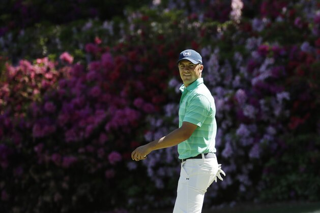 Jordan Spieth looks back to his caddie while on the 13th green during a practice round for the Masters golf tournament, Monday, April 4, 2016, in Augusta, Ga. (AP Photo/Charlie Riedel)