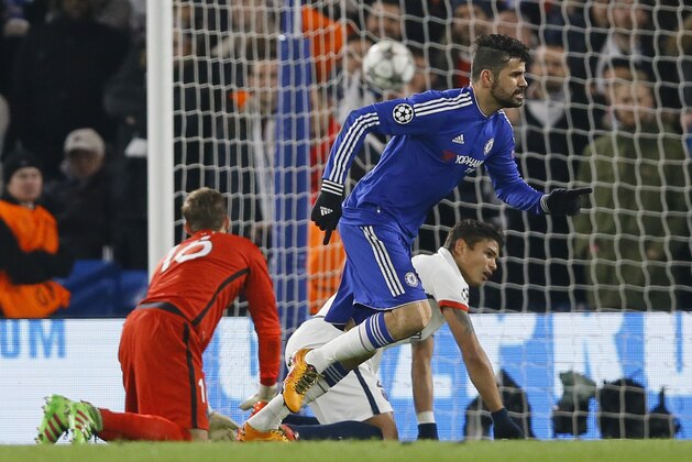 Chelsea's Diego Costa runs to celebrate after he scored his side’s first goal as PSG's Thiago Silva, right, and PSG goalkeeper Kevin Trapp, left, are seen during the round of sixteen second leg Champions League soccer match between Chelsea and Paris Saint-Germain at Stamford Bridge stadium in London, Wednesday, March 9, 2016. (AP Photo/Kirsty Wigglesworth)