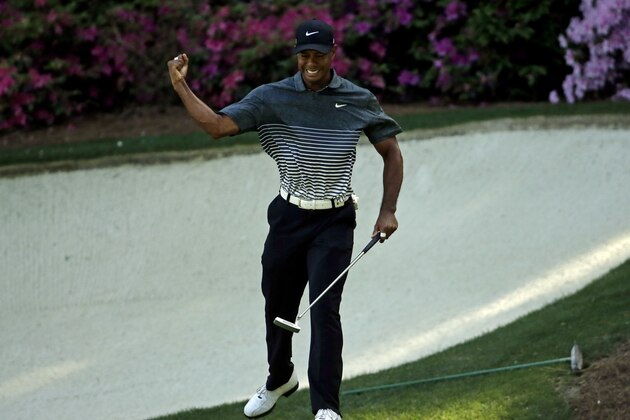 Tiger Woods reacts after a birdie on the 13th hole during the third round of the Masters golf tournament Saturday, April 11, 2015, in Augusta, Ga. (AP Photo/Chris Carlson)