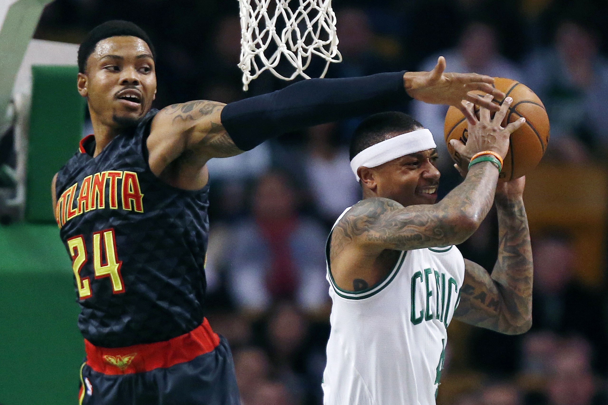 Atlanta Hawks' Kent Bazemore (24) blocks a shot by Boston Celtics' Isaiah Thomas during the first quarter of an NBA basketball game in Boston, Friday, Dec. 18, 2015. (AP Photo/Michael Dwyer)