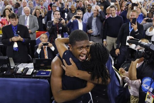 Villanova forward Kris Jenkins is embraced after the NCAA Final Four tournament college basketball championship game against North Carolina Monday, April 4, 2016, in Houston. Villanova won 77-74. (AP Photo/David J. Phillip)