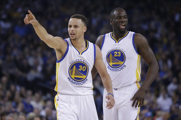 Golden State Warriors' Stephen Curry (30)  agues a call next to teammate Draymond Green during an NBA basketball game against the Boston Celtics Friday, April 1, 2016, in Oakland, Calif. (AP Photo/Marcio Jose Sanchez)