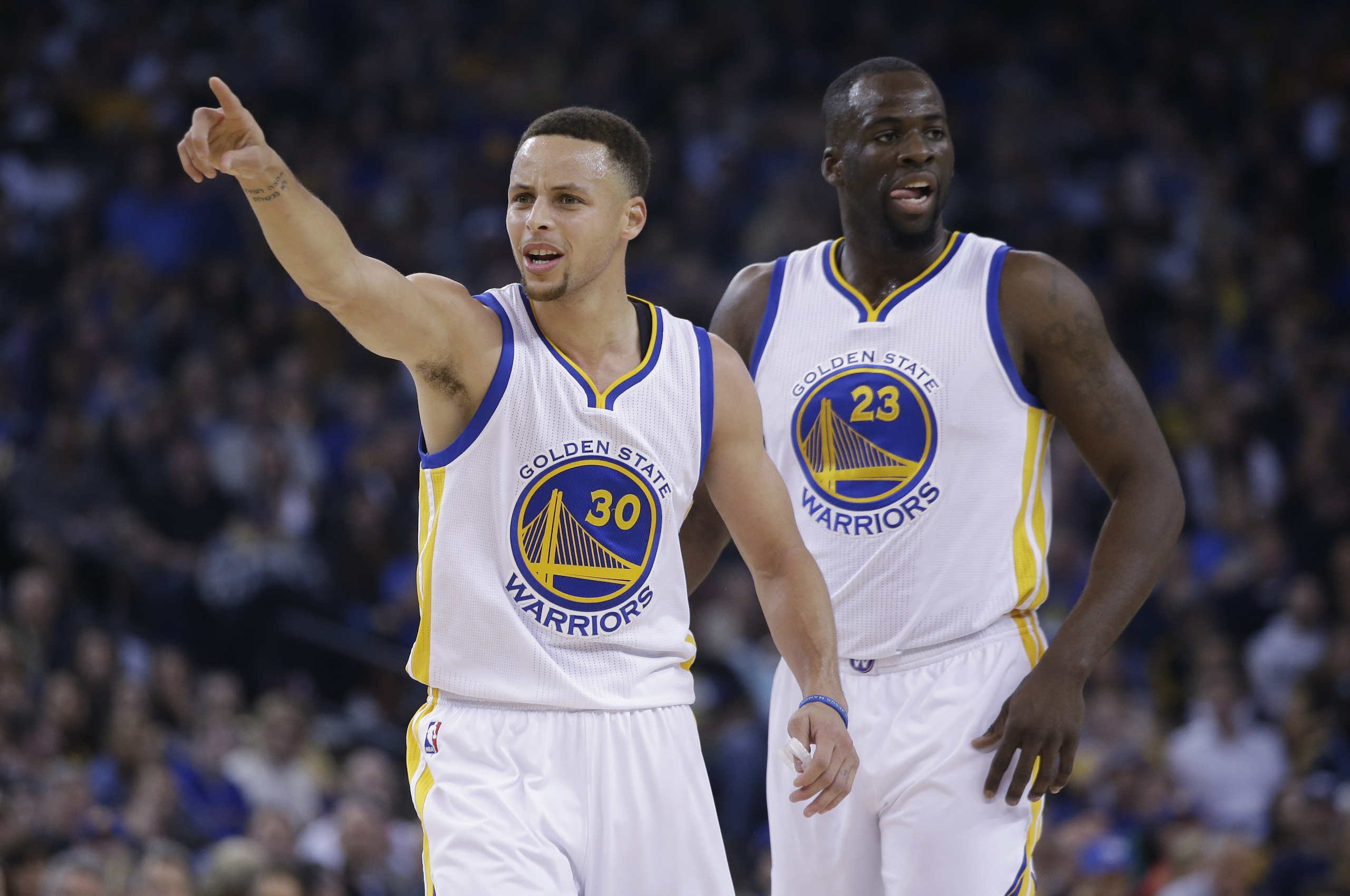 Golden State Warriors' Stephen Curry (30)  agues a call next to teammate Draymond Green during an NBA basketball game against the Boston Celtics Friday, April 1, 2016, in Oakland, Calif. (AP Photo/Marcio Jose Sanchez)