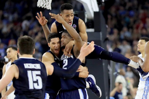 HOUSTON, TEXAS - APRIL 04:  Kris Jenkins #2 of the Villanova Wildcats celebrates with teammates after making the game-winning three pointer to defeat the North Carolina Tar Heels 77-74 in the 2016 NCAA Men's Final Four National Championship game at NRG Stadium on April 4, 2016 in Houston, Texas.  (Photo by Ronald Martinez/Getty Images)