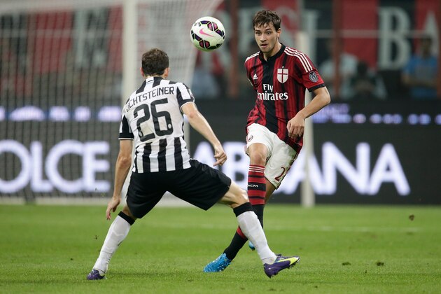 (L-R) Stephan Lichtsteiner of Juventus , Mattia de Sciglio of AC Milan during the Serie A match between AC Milan and Juventus on September 20, 2014 at the Stadio Giuseppe Meazza in Milan, Italy.(Photo by VI Images via Getty Images)